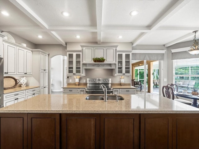 12060 Sapphire Dr, Spring Hill, FL 34609 - kitchen featuring coffered ceiling, a spacious island, recessed lighting, glass insert cabinets, and stainless steel range with electric cooktop
