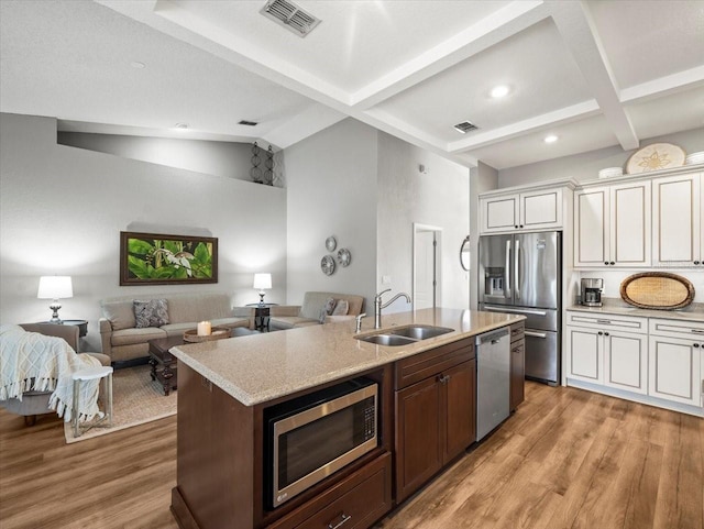12060 Sapphire Dr, Spring Hill, FL 34609 - kitchen featuring appliances with stainless steel finishes, open floor plan, light wood-style flooring, white cabinetry, and recessed lighting