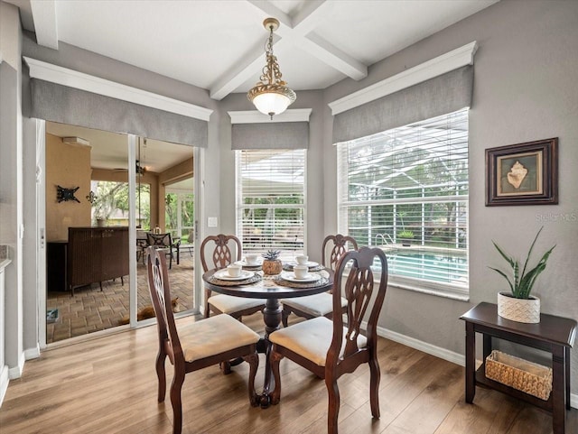 12060 Sapphire Dr, Spring Hill, FL 34609 - dining area with light wood-style flooring, beamed ceiling, healthy amount of natural light, and coffered ceiling