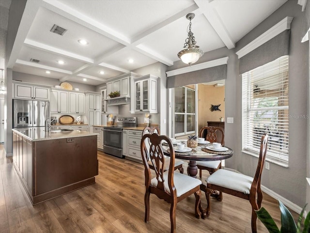 12060 Sapphire Dr, Spring Hill, FL 34609 - kitchen featuring stainless steel appliances, exhaust hood, dark wood-style floors, coffered ceiling, and glass insert cabinets