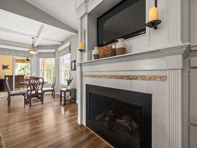 12060 Sapphire Dr, Spring Hill, FL 34609 - dining area view of a tile fireplace, wood finished floors, beam ceiling, and coffered ceiling