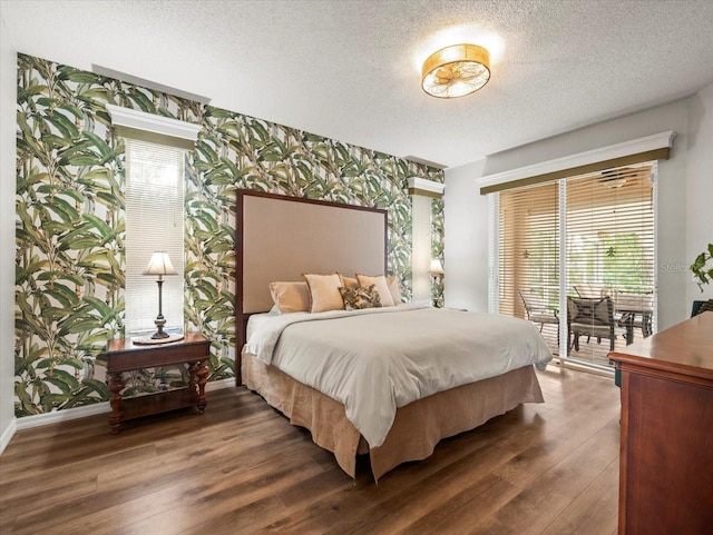 12060 Sapphire Dr, Spring Hill, FL 34609 - bedroom featuring access to exterior, wood finished floors, a textured ceiling, and multiple windows