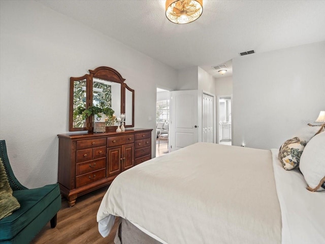 12060 Sapphire Dr, Spring Hill, FL 34609 - bedroom featuring dark wood-type flooring, ensuite bath, and a closet