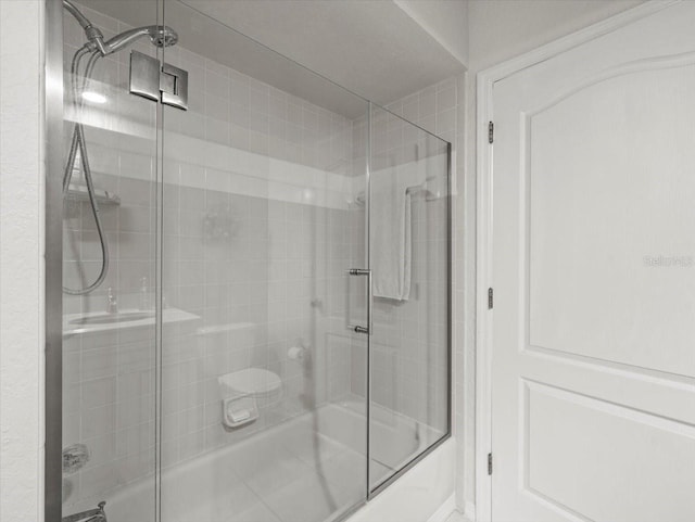 12060 Sapphire Dr, Spring Hill, FL 34609 - bathroom featuring shower / bath combination with glass door