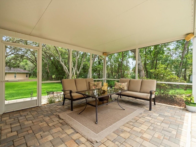 12060 Sapphire Dr, Spring Hill, FL 34609 - sunroom featuring an outdoor hangout area and view of wooded area