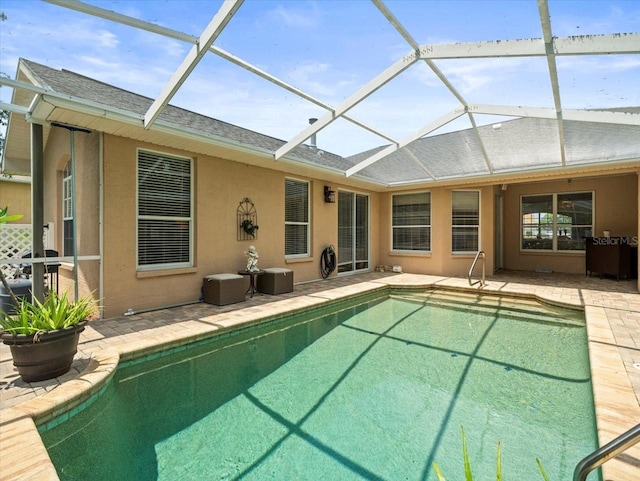 12060 Sapphire Dr, Spring Hill, FL 34609 - rear view of house featuring a patio, a shingled roof, and an outdoor pool