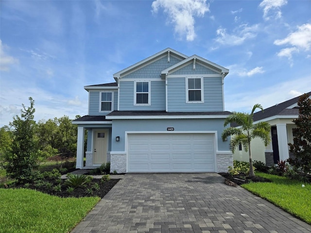 14425 Maiden Ter, Lakewood Ranch, FL 34211 - craftsman inspired home with stone siding, a garage, and decorative driveway
