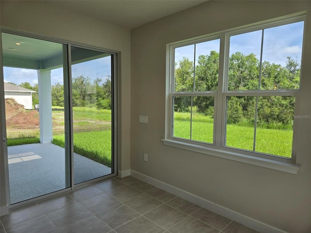14425 Maiden Ter, Lakewood Ranch, FL 34211 - doorway to outside with tile patterned flooring and baseboards