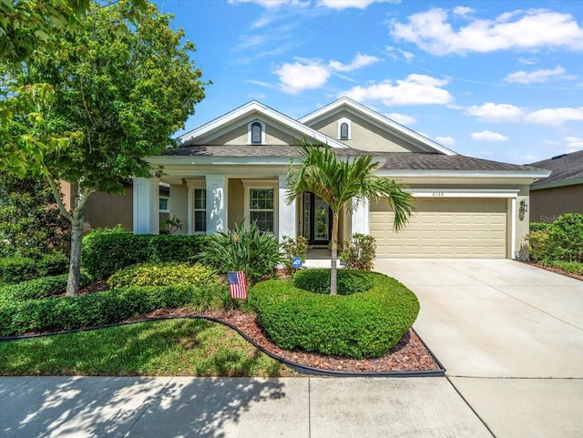 6130 Colmar Pl, Apollo Beach, FL 33572 - single story home with stucco siding, a garage, concrete driveway, and a porch