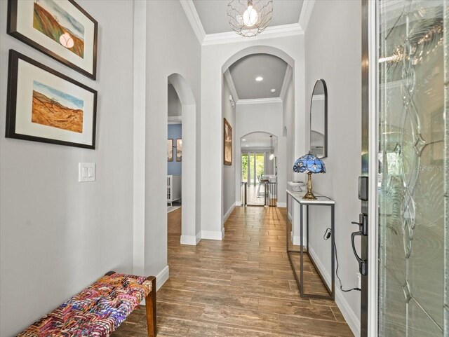 6130 Colmar Pl, Apollo Beach, FL 33572 - corridor featuring arched walkways, ornamental molding, wood finished floors, and recessed lighting