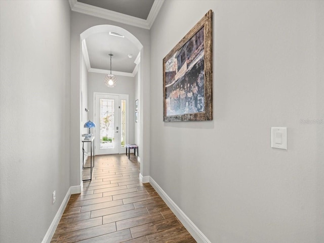 6130 Colmar Pl, Apollo Beach, FL 33572 - hall featuring arched walkways, crown molding, and dark wood-type flooring