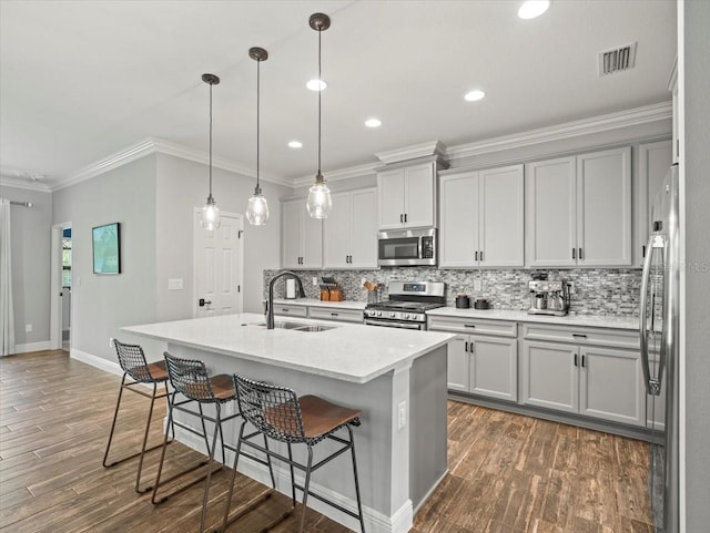 6130 Colmar Pl, Apollo Beach, FL 33572 - kitchen with stainless steel appliances, tasteful backsplash, dark wood finished floors, recessed lighting, and ornamental molding
