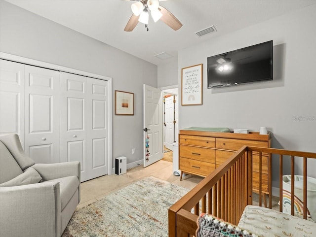 6130 Colmar Pl, Apollo Beach, FL 33572 - bedroom with a closet, a ceiling fan, a nursery area, and light tile patterned flooring