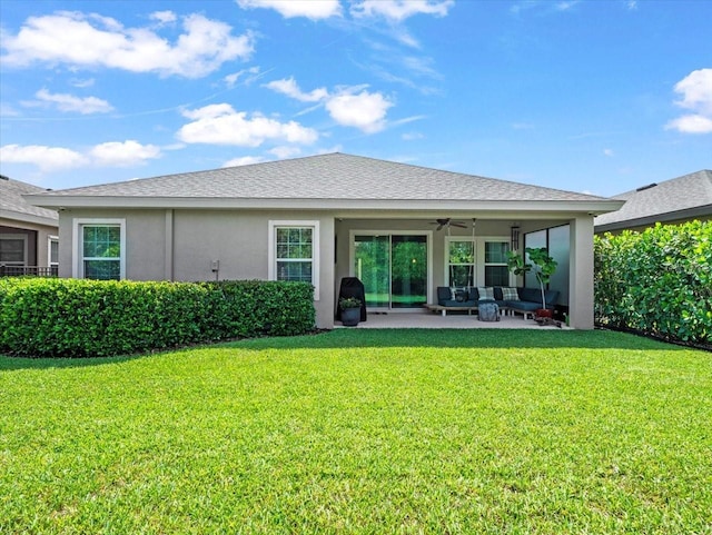 6130 Colmar Pl, Apollo Beach, FL 33572 - rear view of house featuring a ceiling fan, a lawn, a patio area, stucco siding, and an outdoor living space