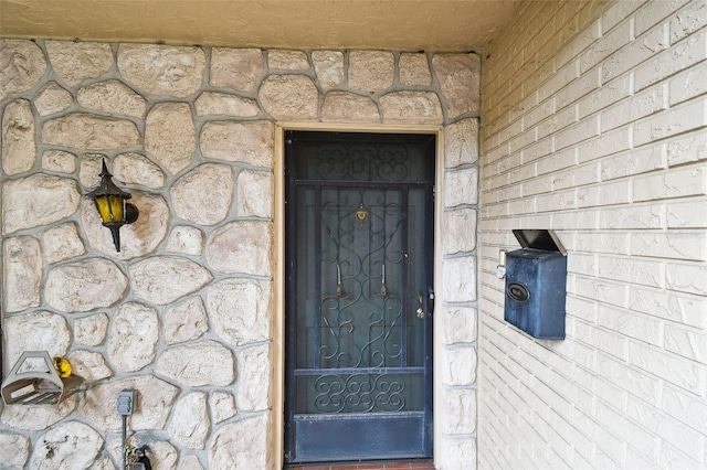 2101 Sunset Point Rd Unit 201, Clearwater, FL 33765 - view of exterior entry featuring stone siding