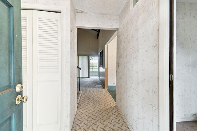 2101 Sunset Point Rd Unit 201, Clearwater, FL 33765 - hallway with a textured ceiling