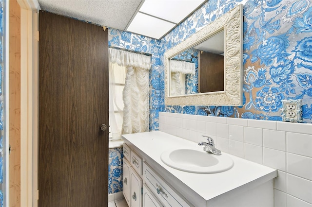 2101 Sunset Point Rd Unit 201, Clearwater, FL 33765 - bathroom featuring wallpapered walls and vanity
