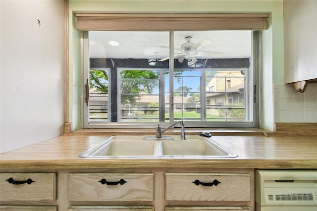 2101 Sunset Point Rd Unit 201, Clearwater, FL 33765 - kitchen with decorative backsplash, plenty of natural light, light countertops, and a ceiling fan