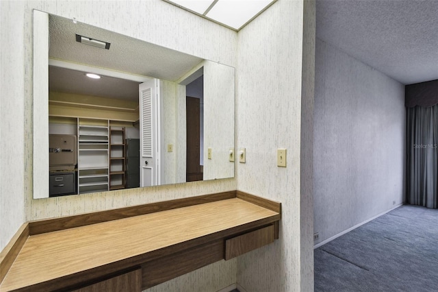 2101 Sunset Point Rd Unit 201, Clearwater, FL 33765 - bathroom featuring a textured ceiling and a closet