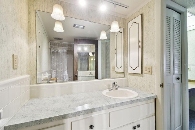 2101 Sunset Point Rd Unit 201, Clearwater, FL 33765 - bathroom with wallpapered walls, vanity, and a closet
