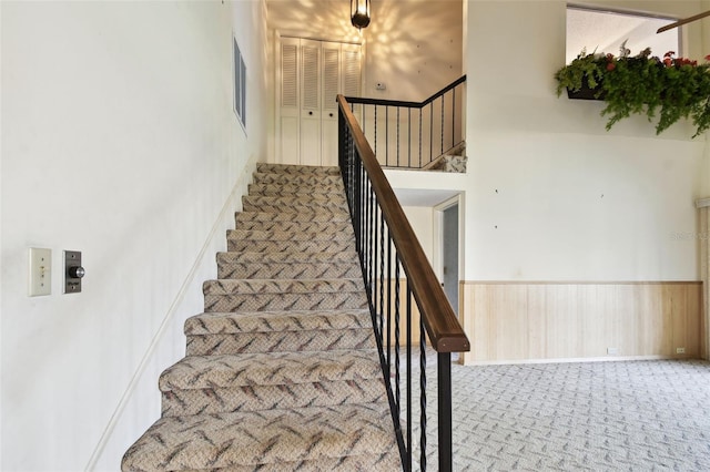 2101 Sunset Point Rd Unit 201, Clearwater, FL 33765 - staircase featuring carpet floors