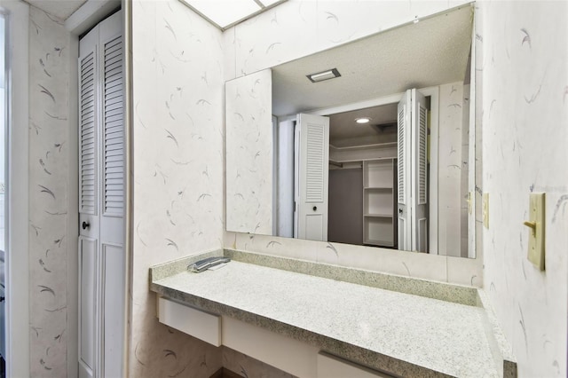 2101 Sunset Point Rd Unit 201, Clearwater, FL 33765 - bathroom with a closet and vanity