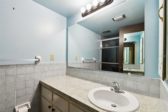 2101 Sunset Point Rd Unit 201, Clearwater, FL 33765 - full bathroom featuring vanity, a shower stall, and a wainscoted wall