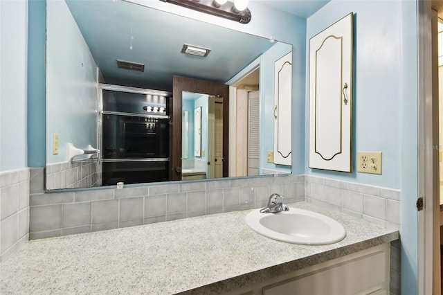 2101 Sunset Point Rd Unit 201, Clearwater, FL 33765 - bathroom with vanity and tasteful backsplash