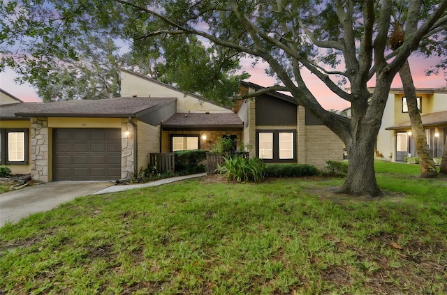 2101 Sunset Point Rd Unit 201, Clearwater, FL 33765 - mid-century inspired home featuring stone siding, driveway, a garage, and a front yard