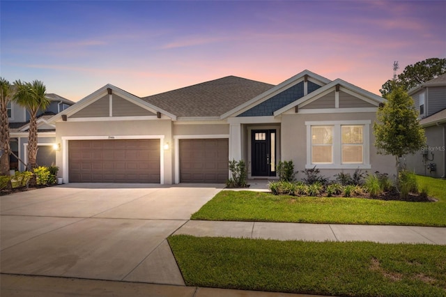 33466 Landsman Loop, Wesley Chapel, FL 33543 - view of front of house with driveway, an attached garage, stucco siding, and a front lawn