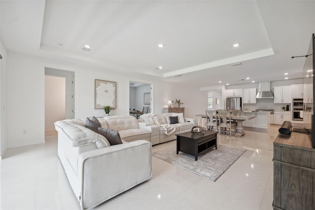 33466 Landsman Loop, Wesley Chapel, FL 33543 - living room featuring a raised ceiling, recessed lighting, and light tile patterned floors