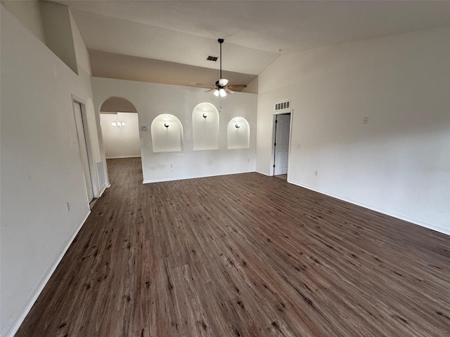 11308 Mahopac Rd, Weeki Wachee, FL 34614 - unfurnished living room featuring ceiling fan, dark wood-type flooring, arched walkways, and vaulted ceiling