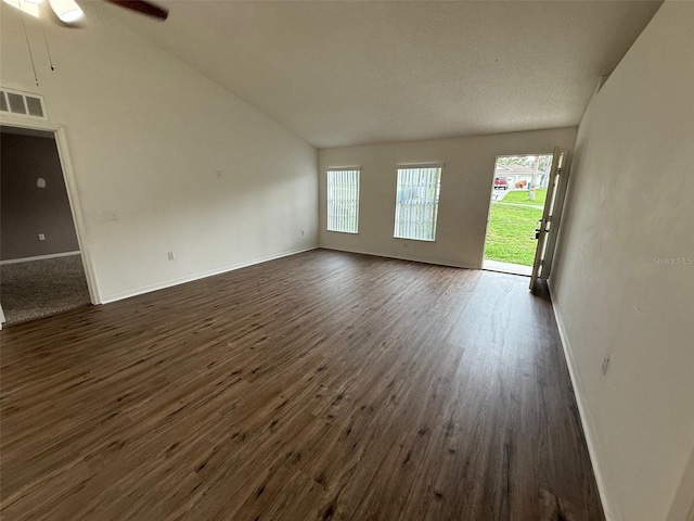 11308 Mahopac Rd, Weeki Wachee, FL 34614 - unfurnished living room with vaulted ceiling, dark wood finished floors, and a ceiling fan