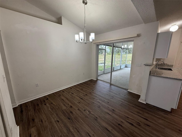 11308 Mahopac Rd, Weeki Wachee, FL 34614 - unfurnished dining area featuring a textured ceiling, dark wood-style floors, a chandelier, and lofted ceiling