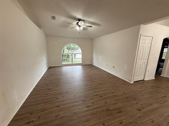 11308 Mahopac Rd, Weeki Wachee, FL 34614 - spare room featuring ceiling fan, dark wood finished floors, arched walkways, and a textured ceiling