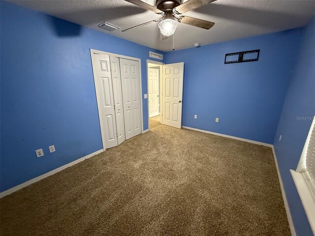 11308 Mahopac Rd, Weeki Wachee, FL 34614 - unfurnished bedroom featuring carpet, a textured ceiling, a closet, and ceiling fan