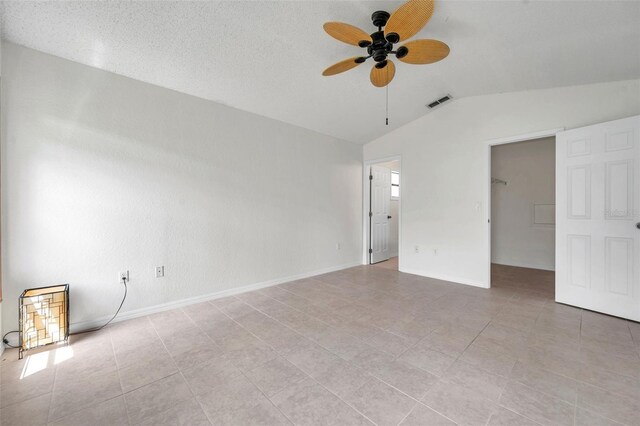 2048 Ground Squirrel Dr, New Port Richey, FL 34655 - unfurnished bedroom with vaulted ceiling, light tile patterned floors, and a ceiling fan