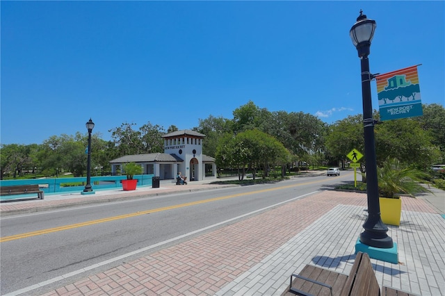 2048 Ground Squirrel Dr, New Port Richey, FL 34655 - view of asphalt road featuring sidewalks, street lights, curbs, and traffic signs