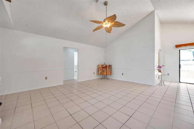2048 Ground Squirrel Dr, New Port Richey, FL 34655 - spare room with a ceiling fan, a textured ceiling, light tile patterned floors, and high vaulted ceiling