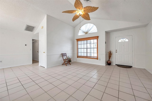 2048 Ground Squirrel Dr, New Port Richey, FL 34655 - foyer entrance featuring a textured ceiling, a ceiling fan, light tile patterned floors, and high vaulted ceiling