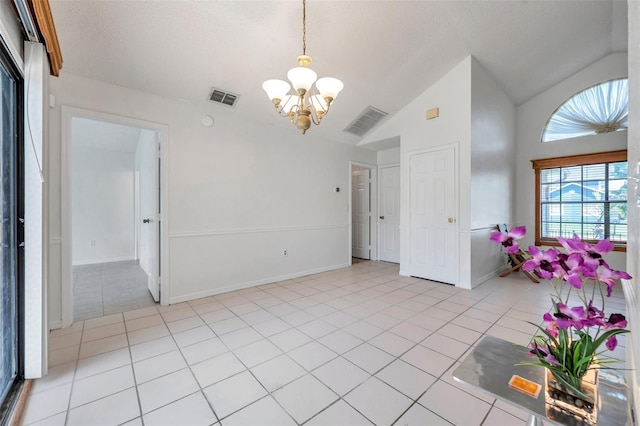 2048 Ground Squirrel Dr, New Port Richey, FL 34655 - entryway with a chandelier, light tile patterned floors, and vaulted ceiling