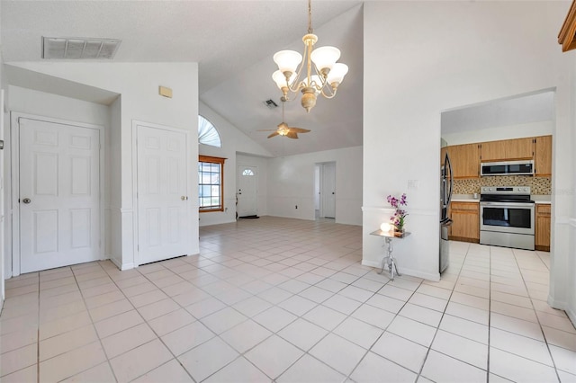 2048 Ground Squirrel Dr, New Port Richey, FL 34655 - kitchen featuring stainless steel appliances, high vaulted ceiling, open floor plan, light countertops, and a chandelier