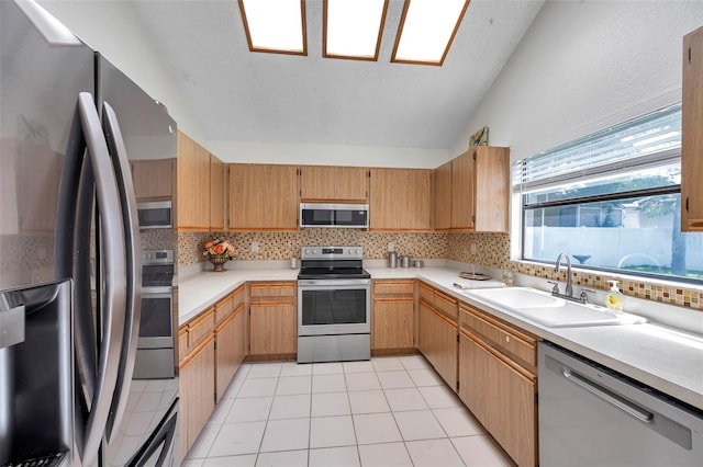 2048 Ground Squirrel Dr, New Port Richey, FL 34655 - kitchen featuring appliances with stainless steel finishes, light countertops, decorative backsplash, lofted ceiling, and light tile patterned floors