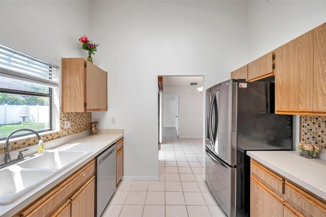 2048 Ground Squirrel Dr, New Port Richey, FL 34655 - kitchen featuring appliances with stainless steel finishes, decorative backsplash, light tile patterned floors, and light countertops