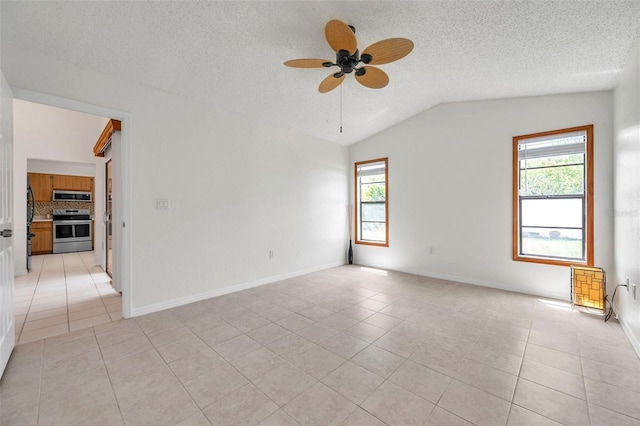 2048 Ground Squirrel Dr, New Port Richey, FL 34655 - unfurnished room featuring light tile patterned floors, vaulted ceiling, a ceiling fan, and a textured ceiling