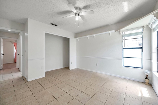 2048 Ground Squirrel Dr, New Port Richey, FL 34655 - unfurnished bedroom featuring light tile patterned floors, a textured ceiling, and ceiling fan