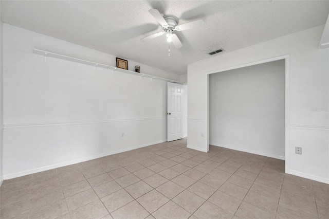 2048 Ground Squirrel Dr, New Port Richey, FL 34655 - unfurnished room with ceiling fan, a textured ceiling, and light tile patterned floors