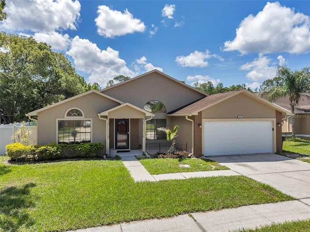 2048 Ground Squirrel Dr, New Port Richey, FL 34655 - view of front of home with stucco siding, a garage, driveway, and brick siding