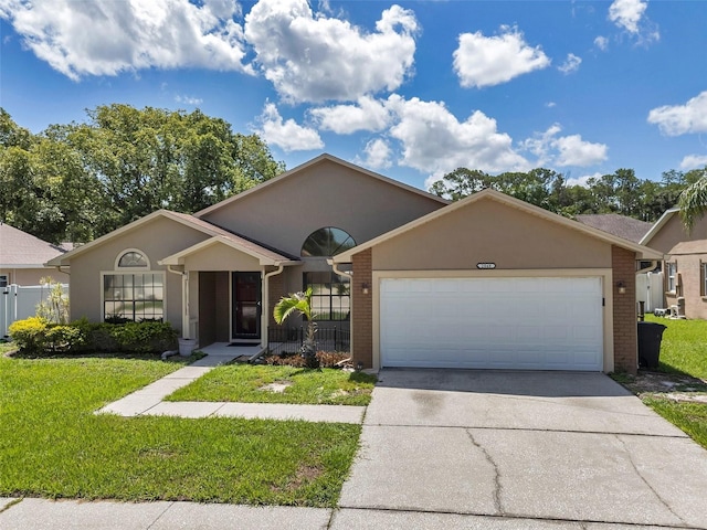 2048 Ground Squirrel Dr, New Port Richey, FL 34655 - ranch-style house featuring brick siding, driveway, an attached garage, and stucco siding