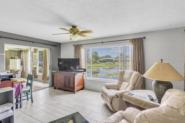 7701 Anaheim Ave, New Port Richey, FL 34655 - living area with plenty of natural light, ceiling fan, a textured ceiling, and light tile patterned floors